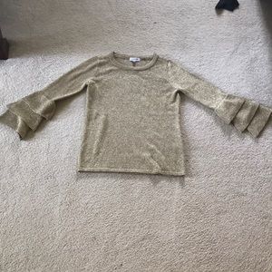 A gold Calvin Klein sweater.